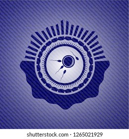 fertilization icon inside badge with denim background