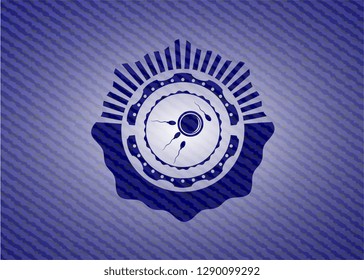 fertilization icon inside emblem with denim texture