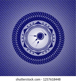 fertilization icon inside emblem with jean texture