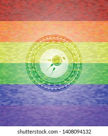 fertilization icon inside emblem on mosaic background with the colors of the LGBT flag