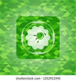 fertilization icon inside green emblem with mosaic background