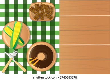 festa junina food table with green corn, carrot cake and sweet kidney top view