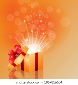 Festive background with open gold box with red satin ribbon bow and confetti