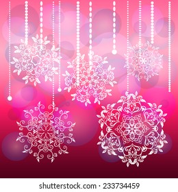 Festive background with snowflakes hanging on chains on pink