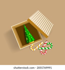Festive banner. Gift box and realistic Christmas decoration. Candy canes and Christmas tree in open box 