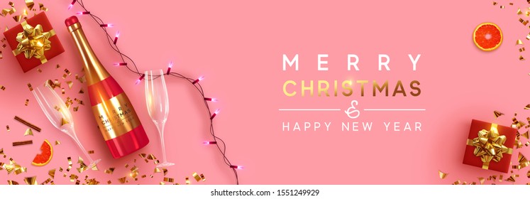 Festive Christmas background. Xmas design with realistic red bottle of champagne and wine, two glasses, sparkling lights garland, gift box, glitter gold confetti. Flat lay, top view. viewed from above