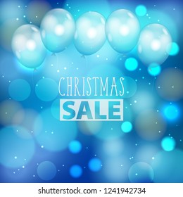 Festive Christmas blue background with defocused lights and white air balloons. Bokeh abstract pattern with promotion Christmas sale text