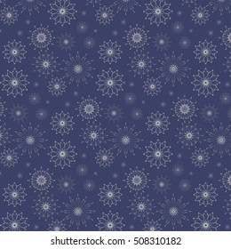 Festive Christmas pattern from gray snowflakes on a blue background.