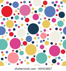 Festive colorful dotted seamless pattern. Random polka dot background. Red, blue, yellow, green circles on white. Spotted abstract seamless pattern. Vector illustration.