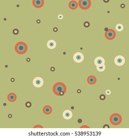 Festive colorful dotted seamless pattern. Random polka dot, rings background. Orange, blue, yellow, brown circles on green. Spotted abstract seamless pattern. Vector illustration.