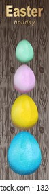 Festive Easter banner with colored eggs.Easter symbol.Background from wooden boards.