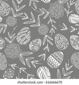 A festive Easter seamless pattern consisting of painted eggs and twigs with leaves and flowers. Line drawing