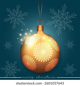 A festive gold Christmas ball with decorative white flowers on a blue backdrop.