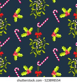 Festive kissing bough seamless vector pattern. Traditional plant tied with red bow. Holly berry and stripes candy cane blue background.