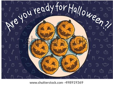 Festive pumpkin cookies lay on a plate on the Halloween day.