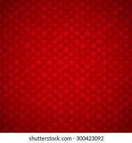 Festive red background with seamless pattern with snowflakes, and with light vignette 