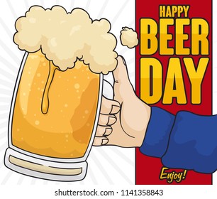 Festive toast with hand holding a delicious beer stein for a happy Beer Day celebration.