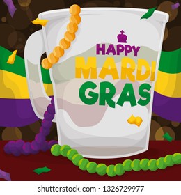 Festive translucent cup with greeting message over tricolor flag to commemorate Mardi Gras with its festive celebration throwing string beads, trinkets and confetti.