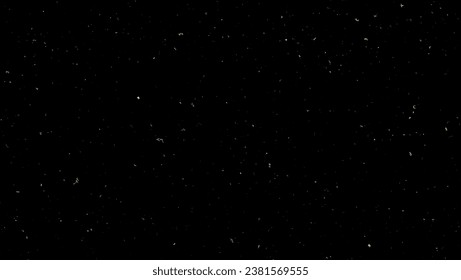 Festive vector background with gold glitter and confetti for christmas celebration. Black background with glowing golden particles.