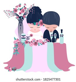 Festive wedding table for the newlyweds, a draped tablecloth with a decor of roses,a decorated bottle of champagne and tall wine glasses, many beautiful candles, a bride dress and groom 