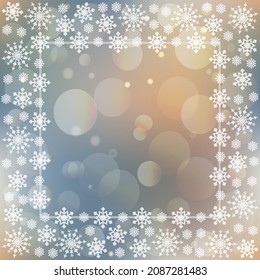 Festive winter copy space template with white snowflakes frame on soft blue, golden and beige blurry bokeh background 
