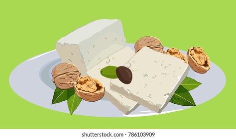 Feta cheese with walnuts on a plate with olives and leaves