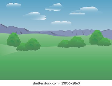 Fields with trees in front of the mountains against the sky with translucent clouds.