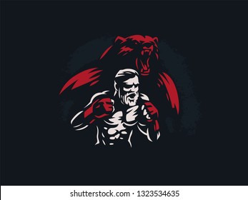 Fighter mixed martial arts is in combat stance. Against the backdrop of the silhouette of a bear.