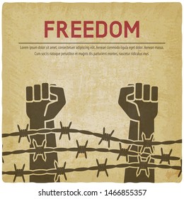 Fighting for freedom concept. Hands clenched into fist behind barbed wire vintage background