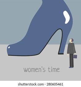 the figure of the man who stands in front of a giant women's shoe