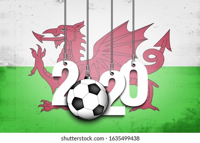 Figures 2020 and soccer ball hanging on strings against the background of the flag of Wales. Design pattern for banner, poster, flyer, invitation. Vector illustration