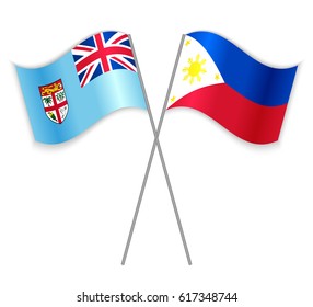 Fijian and Filipino crossed flags. Fiji combined with Philippines isolated on white. Language learning, international business or travel concept.