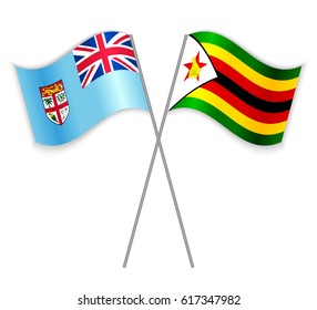 Fijian and Zimbabwean crossed flags. Fiji combined with Zimbabwe isolated on white. Language learning, international business or travel concept.