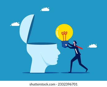 Fill brain with knowledge. Businessman giving a light bulb to the brain 