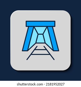 Filled outline Mine entrance icon isolated on blue background.  Vector