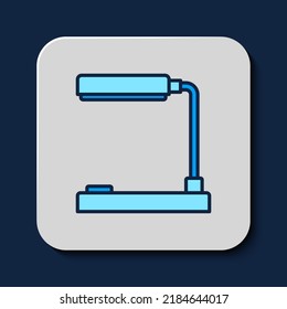Filled outline Table lamp icon isolated on blue background. Table office lamp.  Vector