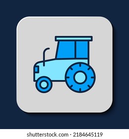 Filled outline Tractor icon isolated on blue background.  Vector