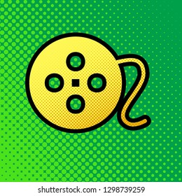 Film circular sign. Vector. Pop art orange to yellow dots-gradient icon with black contour at greenish background.