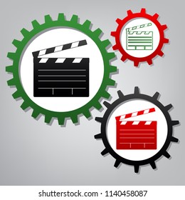 Film clap board cinema sign. Vector. Three connected gears with icons at grayish background.