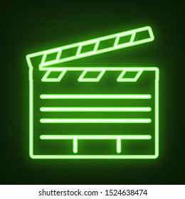 Film clap board cinema sign. Green neon icon in the dark. Blurred lightening. Illustration.