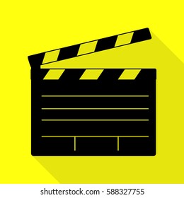 Film clap board cinema sign. Black icon with flat style shadow path on yellow background.