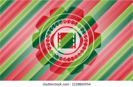 film icon inside christmas colors style badge.