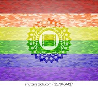 film icon inside emblem on mosaic background with the colors of the LGBT flag