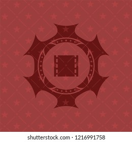 film icon inside red emblem
