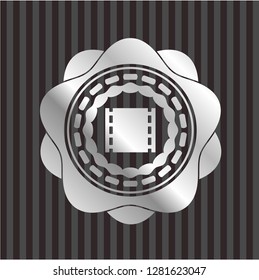 film icon inside silver badge