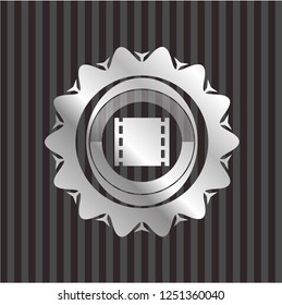 film icon inside silver emblem
