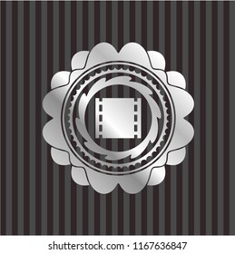 film icon inside silvery badge
