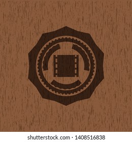 film icon inside wood badge or emblem