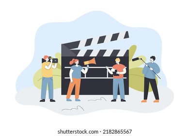 Film making crew shooting video. Tiny male and female characters with equipment and big clapperboard flat vector illustration. Cinema production concept for banner, website design or landing web page