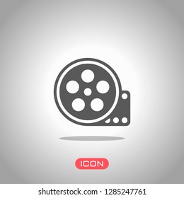 Film roll, old movie strip icon, cinema logo. Icon under spotlight. Gray background